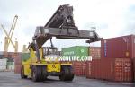 ID 1861 PORT OF AUCKLAND, NZ - A reach-stacker among container stacks at Axis Fergusson Container Terminal.
